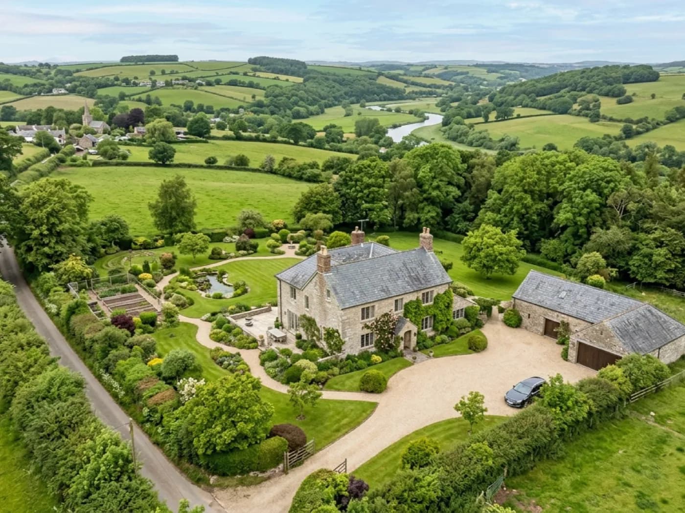 Aerial photograph of a detached house and garden, the kind of wide listing shot an estate agent uses at the top of a brochure
