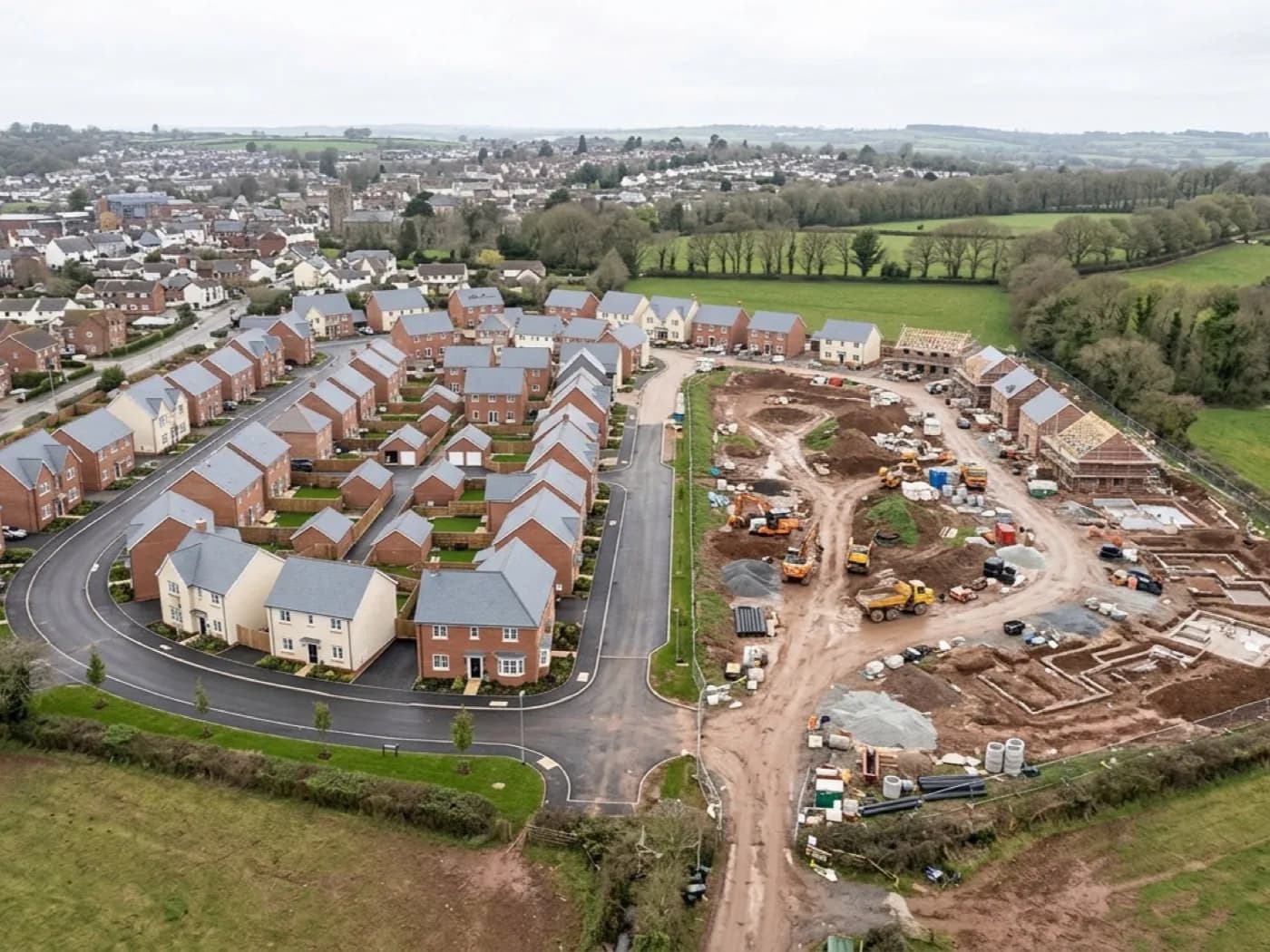 Aerial view of a new housing development under construction on the edge of a Devon town
